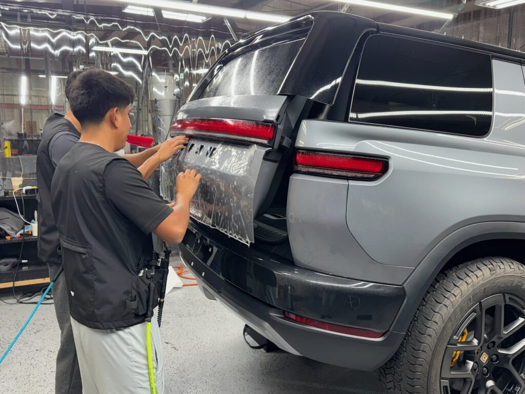 PPF paint protection film being installed on new Rivian R2