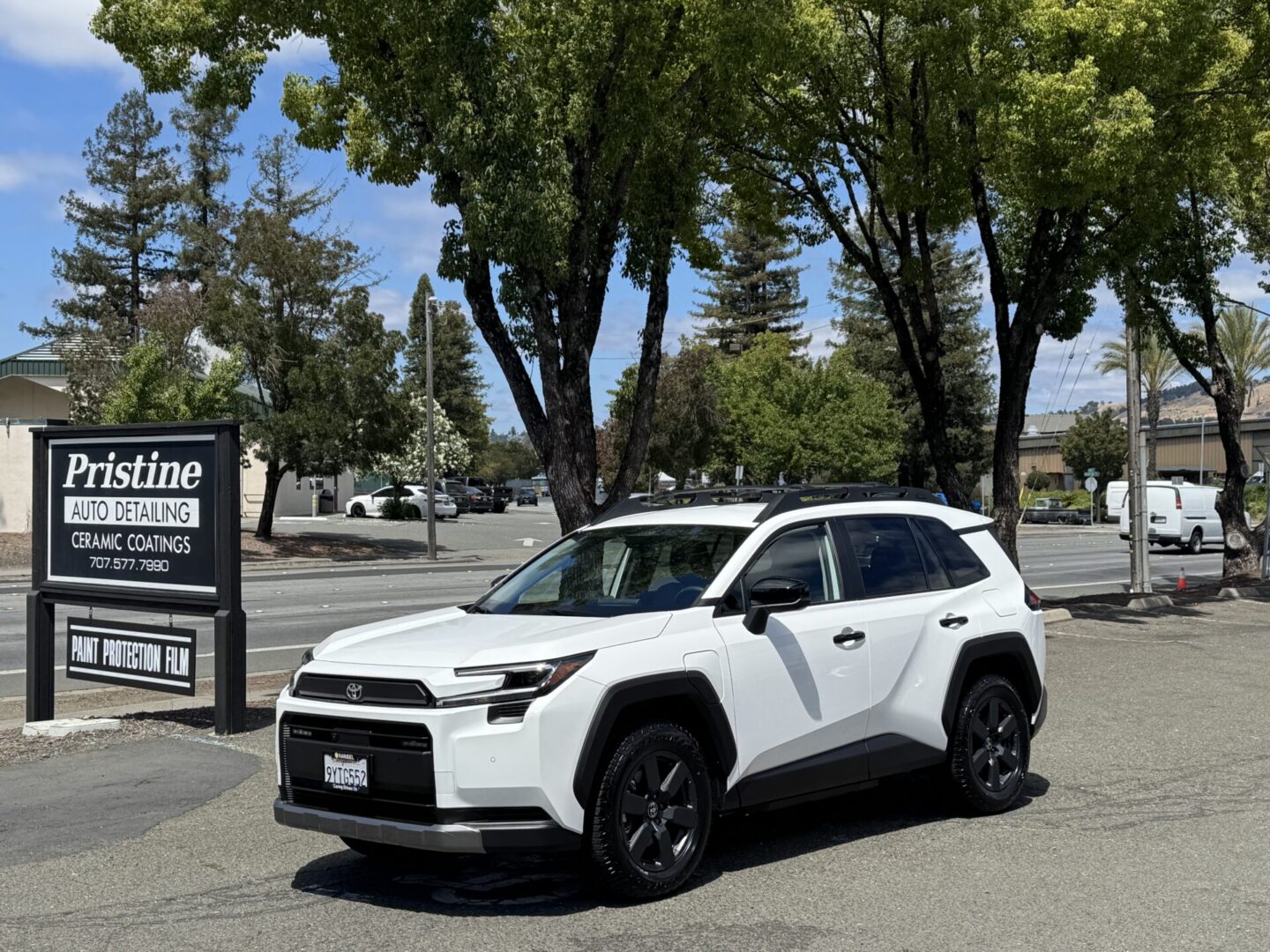 White Toyota RAV4 parked in front of Pristine Auto Detail shop after service