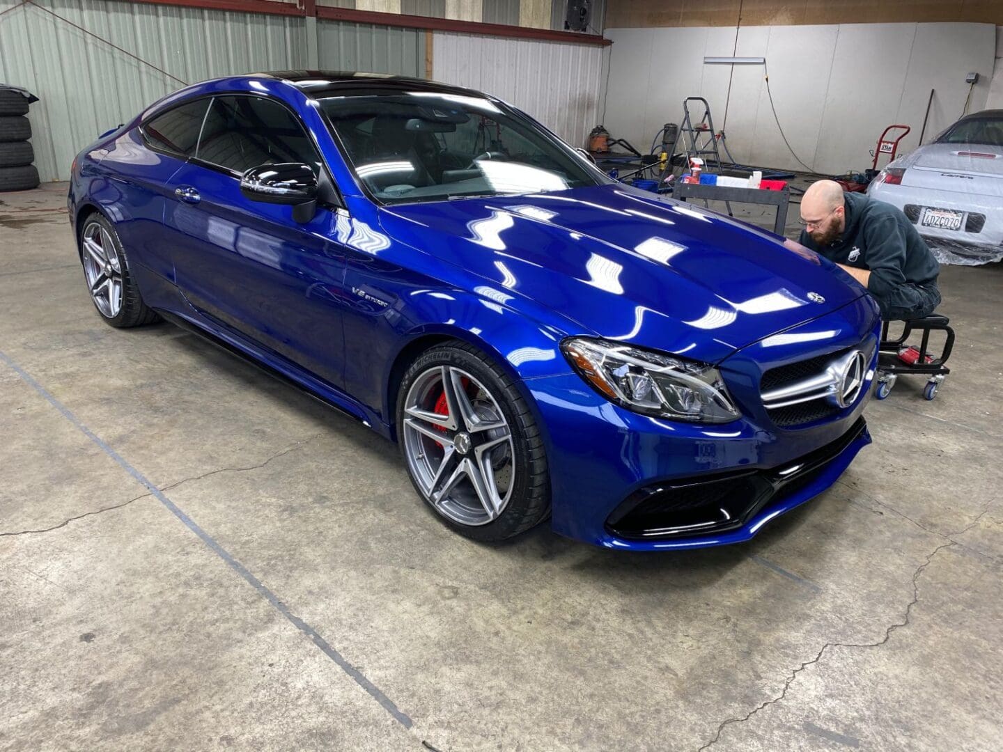 Shiny blue Mercedes during the ceramic coating installation process