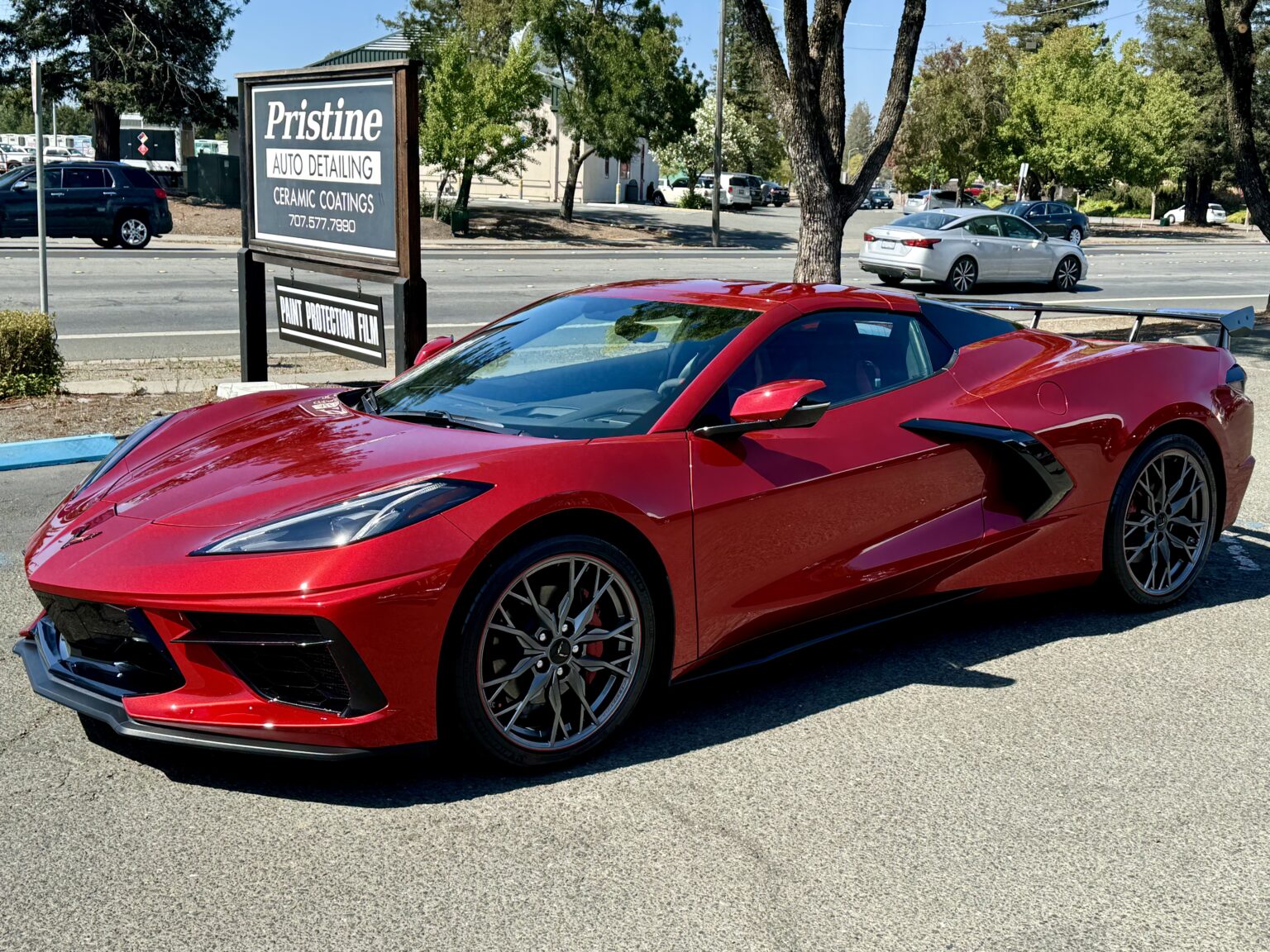 Red Corvette C8 parked outside Pristine Auto Detail after detailing service