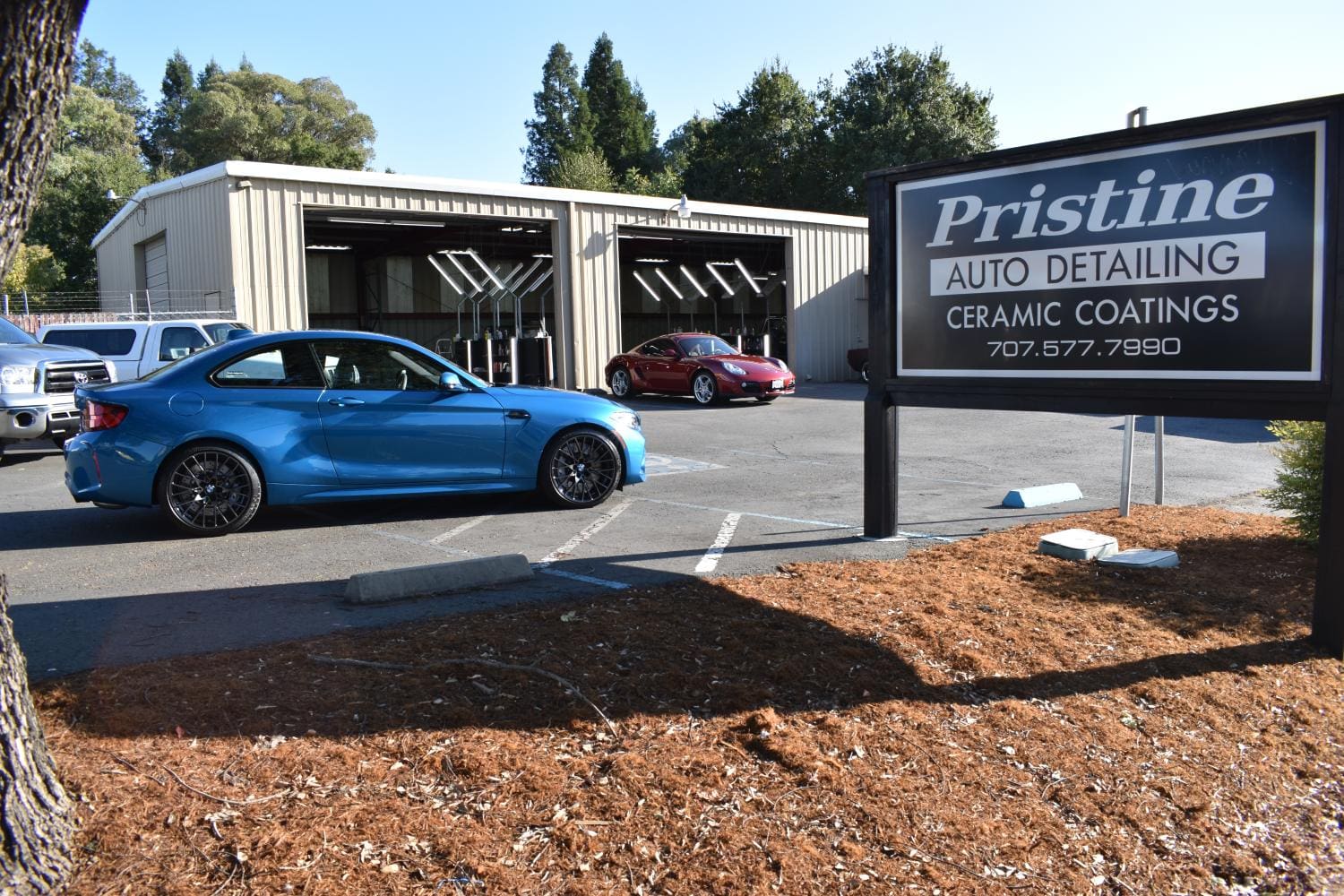 Ceramic Coated Blue sports car parked outside auto detailing shop